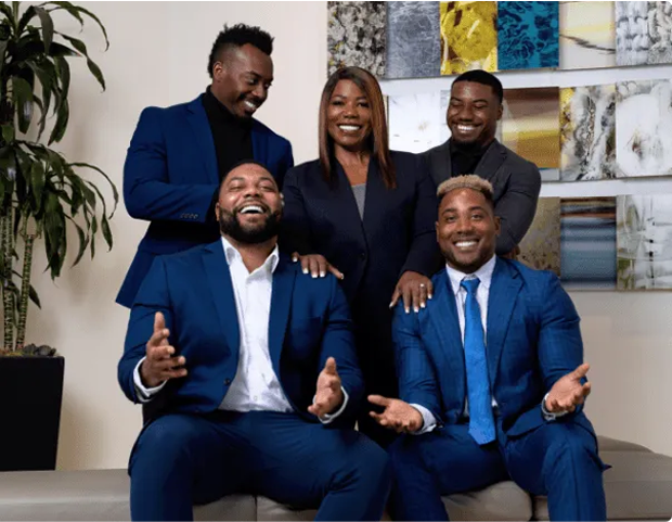 A group photo of the Dennis family, dressed in business attire.